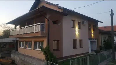 a large house with a porch and a balcony at Apartman View Una in Bihać