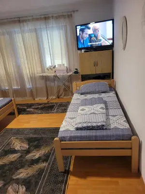 a bedroom with a bed and a flat screen tv at Apartman View Una in Bihać