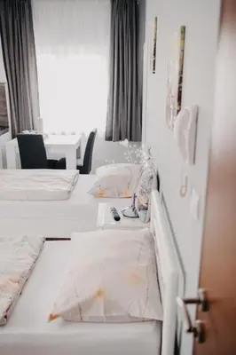 a row of beds in a hotel room at Prenoćište Park in Modriča