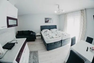 a small room with a bed and a couch at Prenoćište Park in Modriča