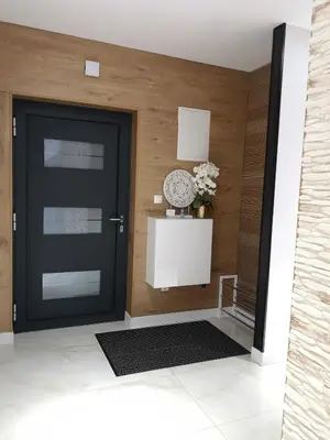 a black door in a room with a table at Villa Diamond in Bihać