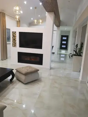 a living room with a fireplace and a tv at Villa Diamond in Bihać