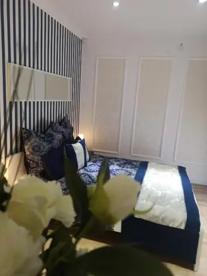 a bedroom with a bed with white flowers in the foreground at Villa Diamond in Bihać