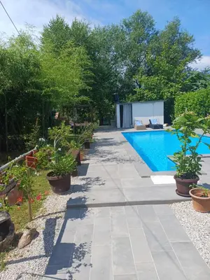 a garden with a swimming pool and plants at Holiday Home Edi in Bihać
