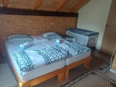 a bedroom with a large bed and a desk at Holiday Home Edi in Bihać