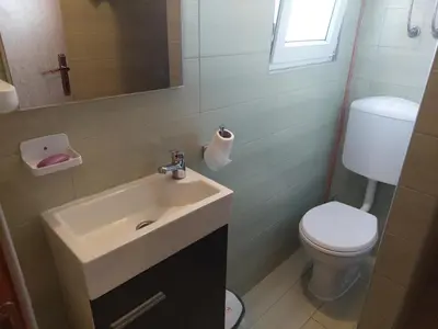 a bathroom with a sink and a toilet at Holiday Home Edi in Bihać