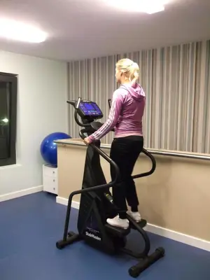 a woman standing on a treadmill in a room at Zepter Hotel in Bosanska Dubica