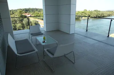 two chairs and a table on a balcony with a view at Zepter Hotel in Bosanska Dubica