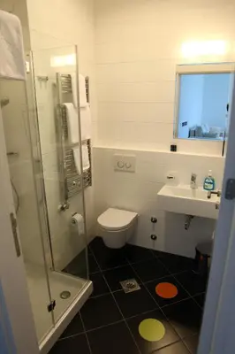 a bathroom with a toilet and a sink and a shower at Zepter Hotel in Bosanska Dubica