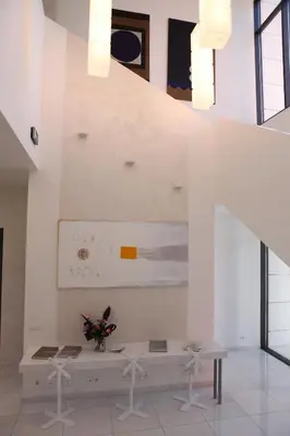 a white room with a bench and a staircase at Zepter Hotel in Bosanska Dubica