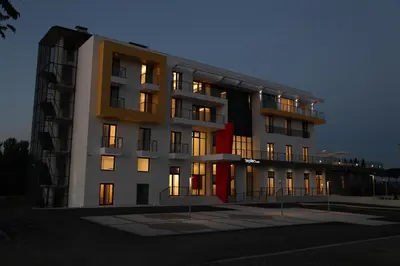 a tall building with its lights on at Zepter Hotel in Bosanska Dubica