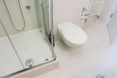 a bathroom with a toilet and a shower at Grande Plus Apartment Dzungla in Doboj