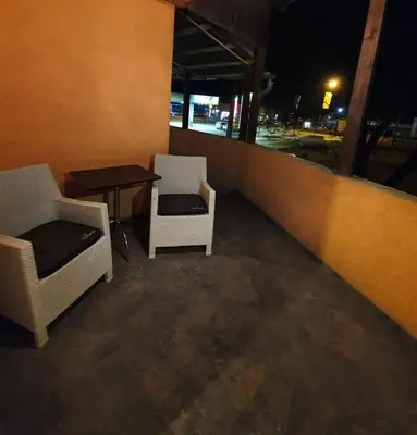 two chairs and a table on a balcony at night at Apartman Marković in Bosanski Šamac