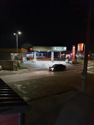 a car parked in front of a gas station at night at Apartman Marković in Bosanski Šamac