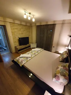 a large bed in a room with a television at Apartman Marković in Bosanski Šamac