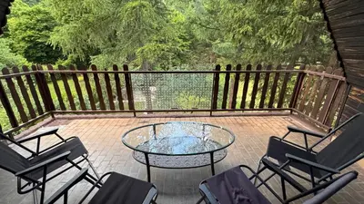 a patio with a table and chairs and a fence at Lodge Zbilje Visoko, Bosnian Pyramids in Visoko