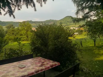a picnic table with a view of a field at Lodge Zbilje Visoko, Bosnian Pyramids in Visoko