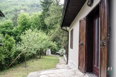 an open door of a house with a view of a yard at Lodge Zbilje Visoko, Bosnian Pyramids in Visoko