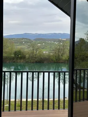 a view of a lake from a porch at Apartments MLIN in Bihać