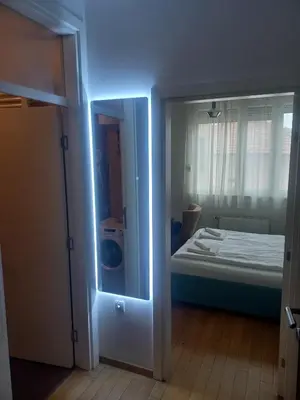 a room with a door to a room with a bed at NM apartman in Banja Luka