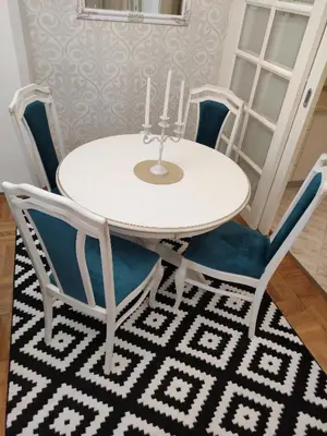 a white table and chairs with two candles on top at Apartment Dajak Centar in Banja Luka