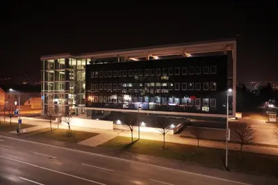 a large building with lights in front of it at night at Apartment Dajak Centar in Banja Luka