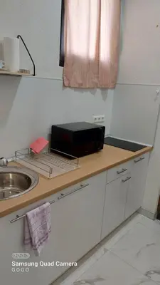 a kitchen counter with a sink and a box on it at Studio Apartman Malkoc in Bihać
