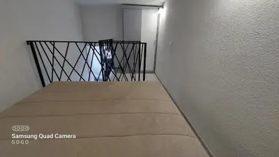 a stair case with a box in a room at Studio Apartman Malkoc in Bihać