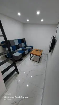 a living room with a couch and a coffee table at Studio Apartman Malkoc in Bihać