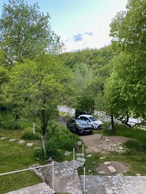 a car parked in a parking lot next to trees at Atlantis Home in Kulen Vakuf