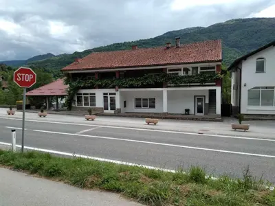 a stop sign in front of a building on a street at Sam guest house in Jajce