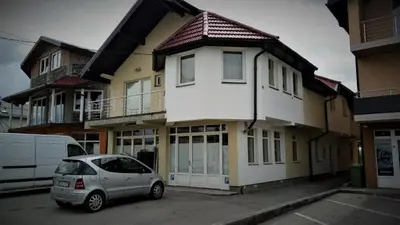 a white car parked in front of a house at Apartments&Rooms Mido in Visoko