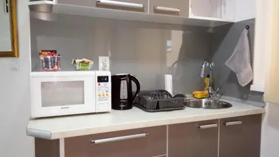 a kitchen counter with a microwave and a sink at Apartments&Rooms Mido in Visoko