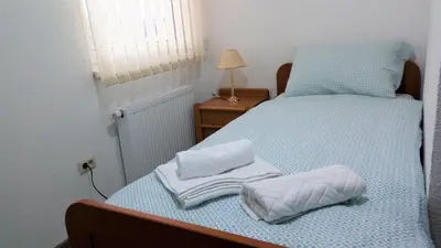 a bedroom with a bed with towels on it at Apartments&Rooms Mido in Visoko