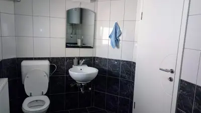 a bathroom with a toilet and a sink at Apartments&Rooms Mido in Visoko
