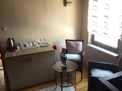 a living room with a table and a chair at Villa Irena in Visoko