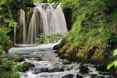a waterfall in the middle of a river at Domacinstvo na kraju svijeta in Šipovo