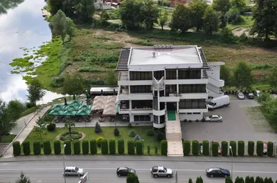 an aerial view of a building with cars parked in a parking lot at Hotel Le Pont in Prijedor