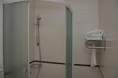a shower with a glass door in a bathroom at Hotel Le Pont in Prijedor