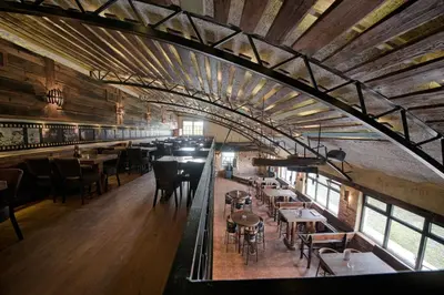 a large room with tables and chairs in a restaurant at Etno Village Cardaci in Vitez