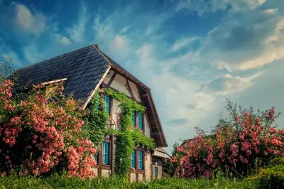 a house with flowers on the side of it at Etno Village Cardaci in Vitez