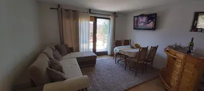 a living room with a couch and a table at Green Paradise in Visoko