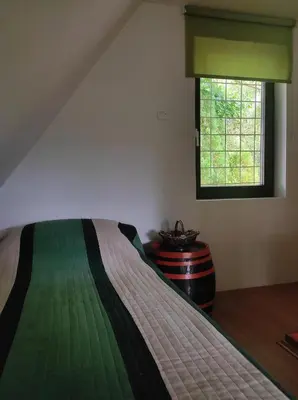 a bedroom with a bed and a window at Green Paradise in Visoko