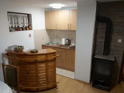 a kitchen with a table and a stove at Green Paradise in Visoko