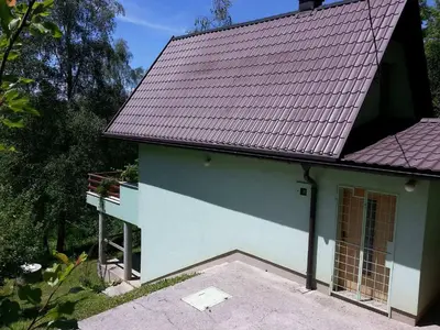 a small house with a red roof and a driveway at Green Paradise in Visoko