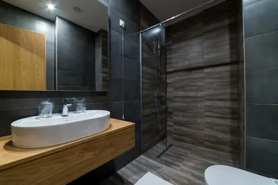 a bathroom with a sink and a shower at Hotel Safir in Bihać