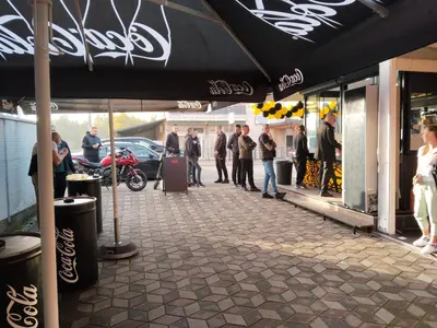 a group of people standing outside of a store at Apartman Nik-Rom in Bosanska Gradiška