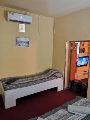 a small room with a bed in the corner of a room at Apartman Nik-Rom in Bosanska Gradiška