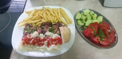 a plate of food with a sandwich and french fries at Apartman Nik-Rom in Bosanska Gradiška