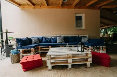 a living room with a blue couch and a table at Apartman Ena in Bihać
